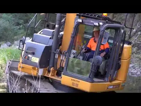 Excavator operator works on site
